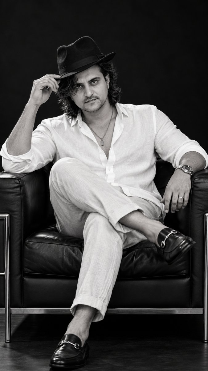 White Linen Shirt Fedora Hat Chair Pose Long Hair - Black And White Studio Luxury Portrait. Diinesh Patel AI Prompt Visual